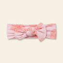 Bow Headband on clean warm ivory background, zero shadows — CULTR editorial product photo