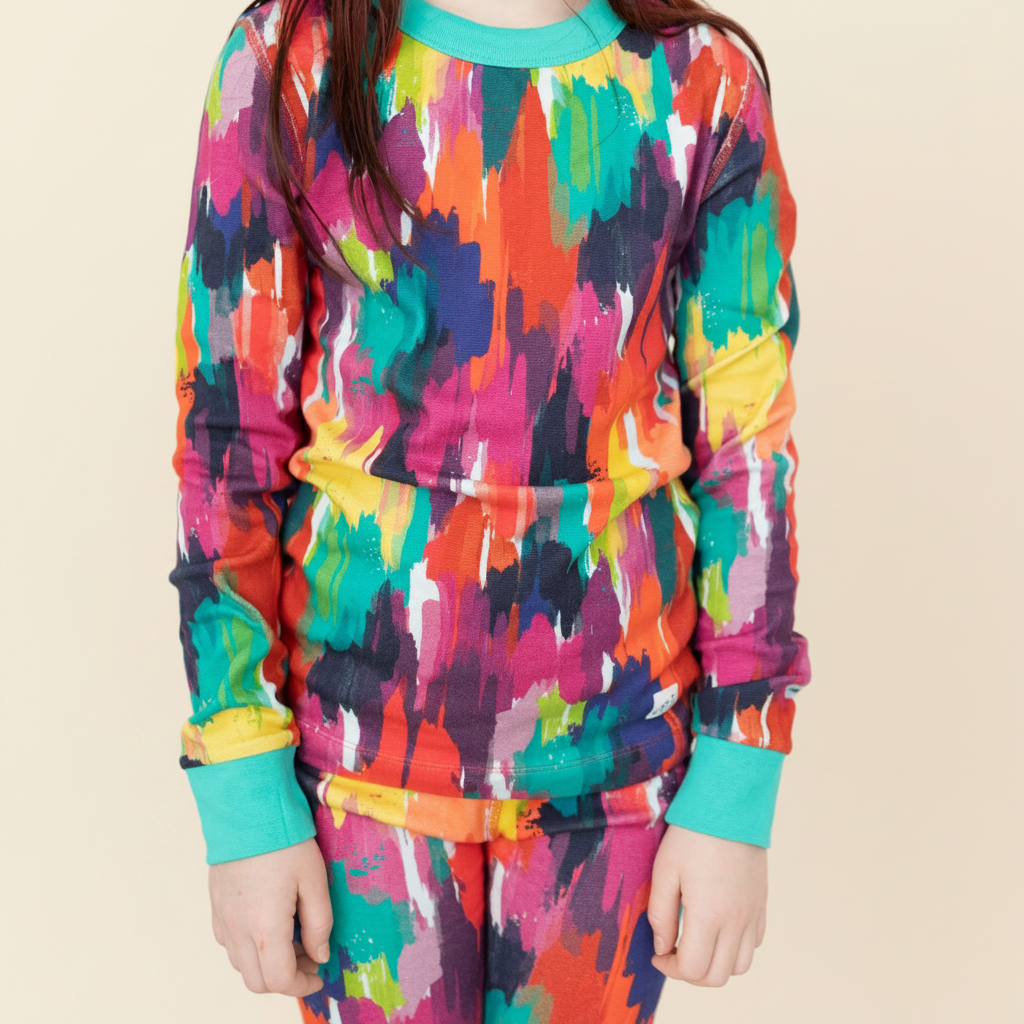 Big Kid Pajama Set – Holi Hues with model on ivory background