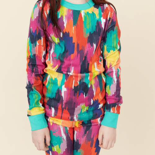 Big Kid Pajama Set – Holi Hues with model on ivory background
