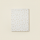 Crib Sheet flat lay on clean warm ivory background, zero shadows — CULTR editorial product photo