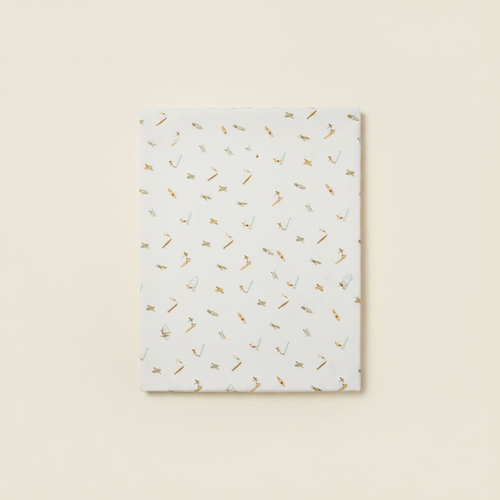 Crib Sheet flat lay on clean warm ivory background, zero shadows — CULTR editorial product photo