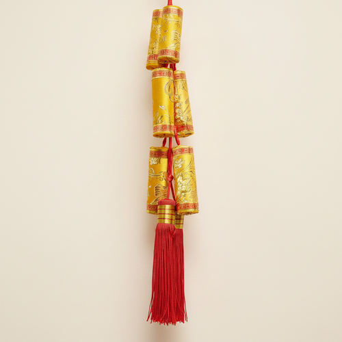 Lunar New Year Firecracker Hanging Gold on clean warm ivory background, zero shadows — Bo & Mei editorial product photo