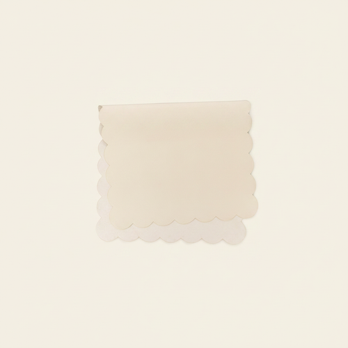 Vegan Leather Changing Mat Cream Scallop on clean warm ivory background, zero shadows — CULTR editorial product photo