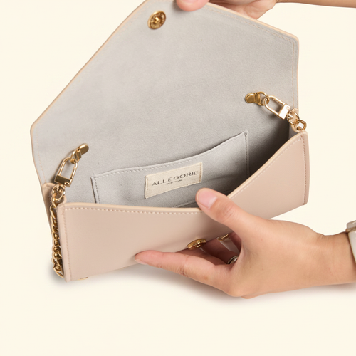 Gala Clutch Wallet-on-Chain Pink model with natural shadow on warm ivory background