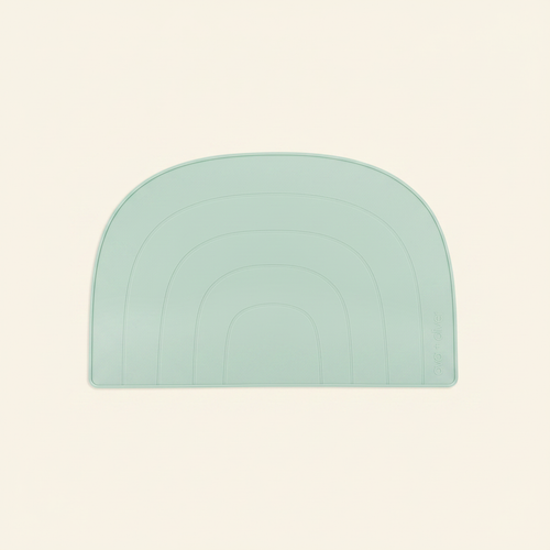 Rainbow Placemat on clean warm ivory background, zero shadows — CULTR editorial product photo