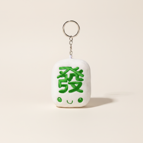 Fat Choy Fa Cai Green Dragon Plush Keychain on clean warm ivory background, zero shadows — Bo & Mei editorial product photo