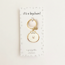 Bao Dumpling Enamel Keychain on warm ivory background