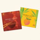 Doubly Happy and Doubly Lucky book on clean warm ivory background, zero shadows — CULTR editorial product photo