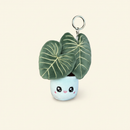 Philodendron Gloriosum Plush Keychain on clean warm ivory background, zero shadows — Blushiez editorial product photo