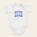 AIYA Onesie flat lay on clean warm ivory background, zero shadows — CULTR editorial product photo