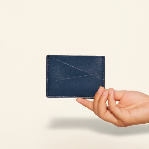 Gala Puzzle Cardholder Navy model with natural shadow on warm ivory background
