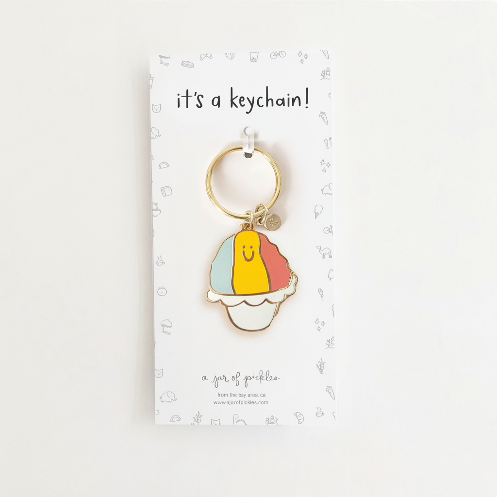 Shave Ice Enamel Keychain on clean warm ivory background with flat ambient light — CULTR editorial product photo