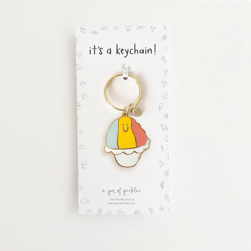 Shave Ice Enamel Keychain on clean warm ivory background with flat ambient light — CULTR editorial product photo