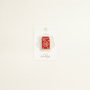 Lunar New Year Lucky Red Envelope Pin on clean warm ivory background with flat ambient light — CULTR editorial product photo